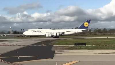 amazing shot of a landing 747 taken from. a taking off 737 on a parallel runway