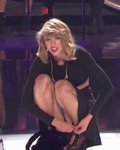 Crouching down in a skirt with a peak ...