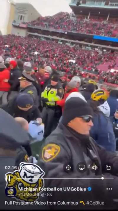 Cops deploying pepper-spray to break up the fight between Michigan&Ohio State players