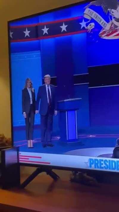 Joe Biden gets a hug from Jill Biden. Trump tries to force something from Melania.