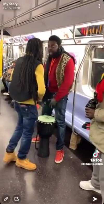 2 men argue on nyc subway over drum playing