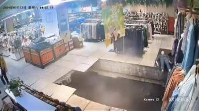 Woman swallowed up as the floor of a shopping centre suddenly collapses 