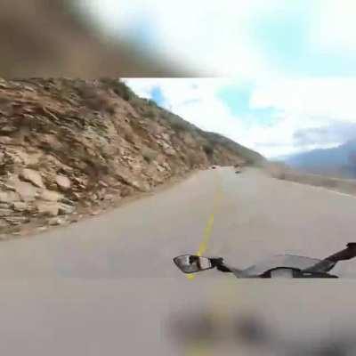 Guy On His Motorcycle Lowsides Off of The Side of A Cliff