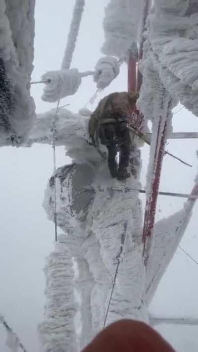 Removing ice from cell tower during winter