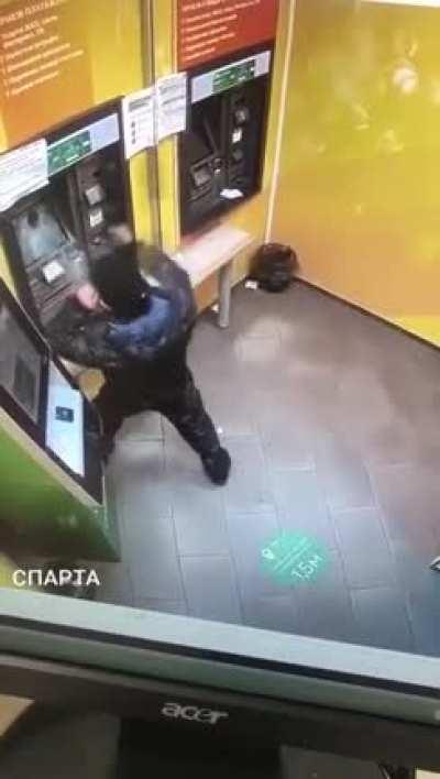 Angry dude takes on ATM with a frying pan.