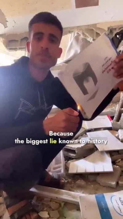 A Palestinian in Gaza makes a statement by burning a book, which once held a special place in his heart