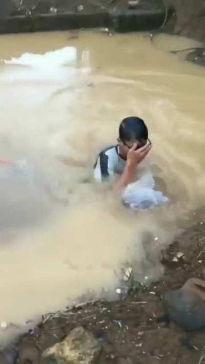 Trying to look cool while drinking soda from a bag.