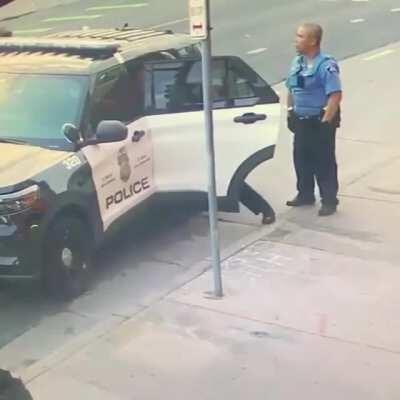 New footage shows police beating George Floyd in car. One stands watch, whilst others attack him.