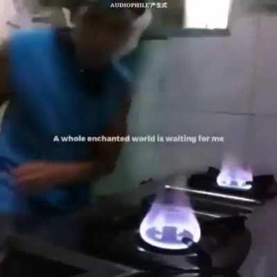 DJ dancing to Music on stove while light is flashing