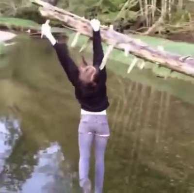 Trying to grab onto a dead tree above a creek