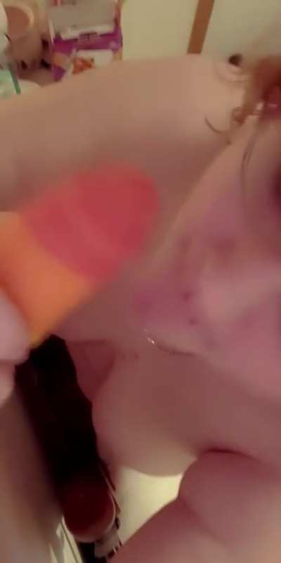 Tongue piercing rainbow lollipop