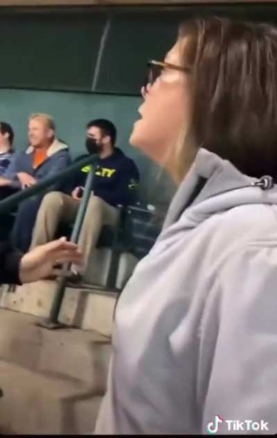 Woman Flashes her t*ts in a stadium. Mother gets mad as her kids saw the t*ts. Crowed throws beer on mad mother.