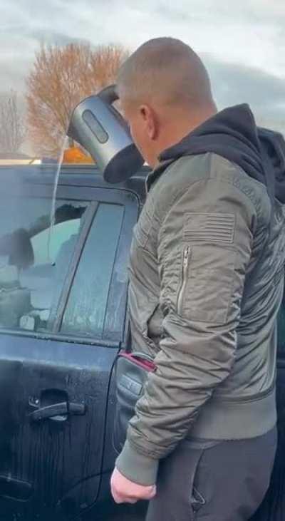 Clearing the ice off the car window with boiling hot water. * I made this a gif as the sound effects were terrible for this video.