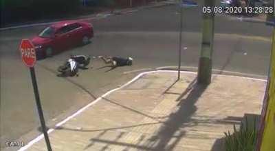 Biker crashes into car and falls into sewage