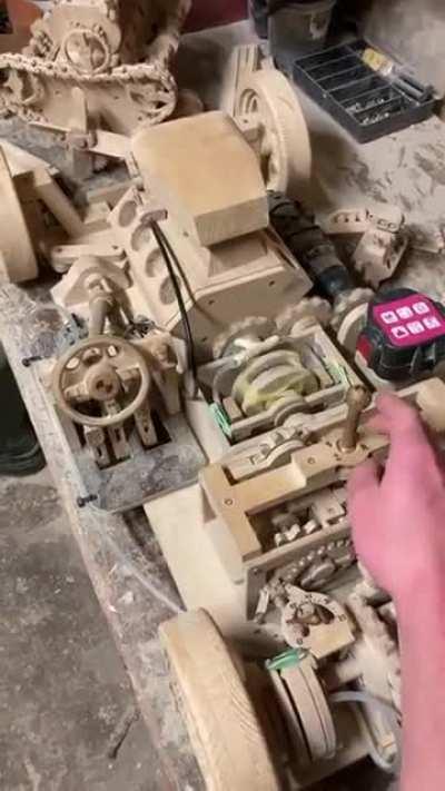 This person builds a miniature working car out of wood.