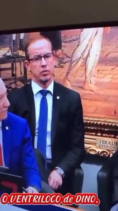 The man behind is acting strangely