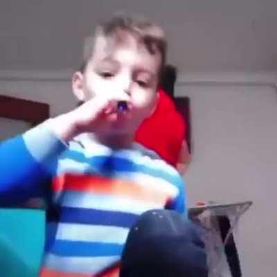 kid vapes while own mother is behind him