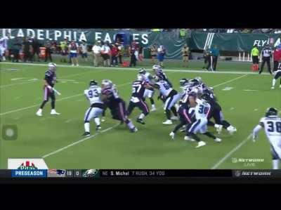 JJ Taylor putting a man in a washing machine and sitting him down.