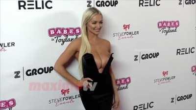 Lindsey Pelas' tits are so big that she have to push them back