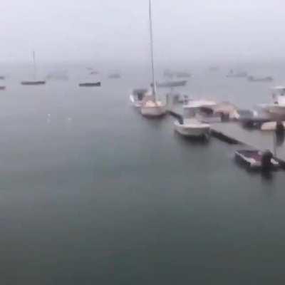 Huge lightning strikes sailboats.