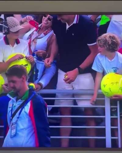 A man grabs Kamil Majchrzak's hat that the player wanted to give to a kid.
