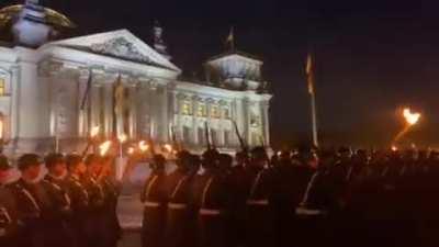 As part of a larger event to honour German troops that fought in Afghanistan, soldiers with torches march in front of the Bundestag.