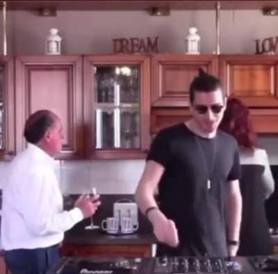 Parents enjoy music with son as they hang on together.