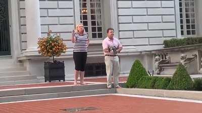 A couple has come out of their house and is pointing guns at protesters in their St. Louis neighborhood