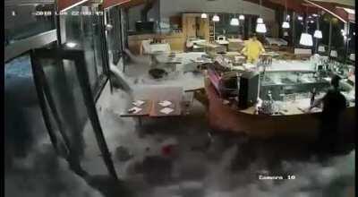 Wave crushes through restaurant windows, Italy, 2/11/2018