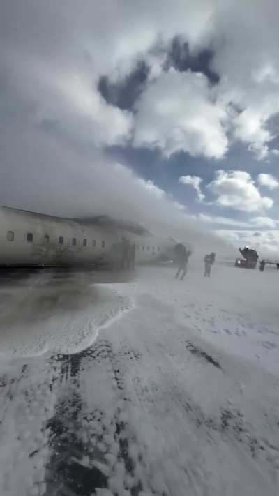 Flight attendants evacuating passengers from the upside down Delta plane that crashed in Toronto