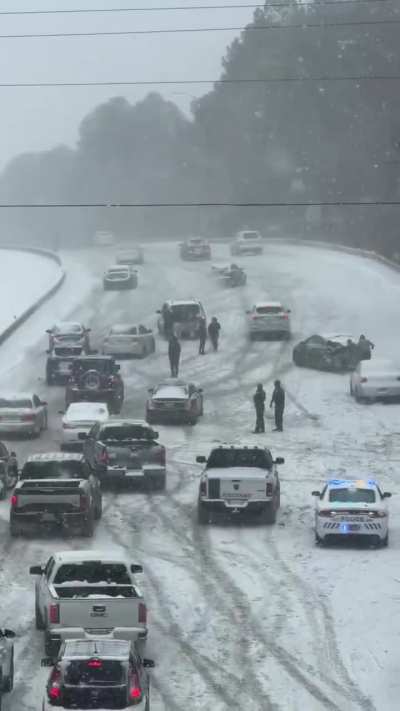 Drivers in North Carolina attempt to navigate crossing a bridge during the snowstorm