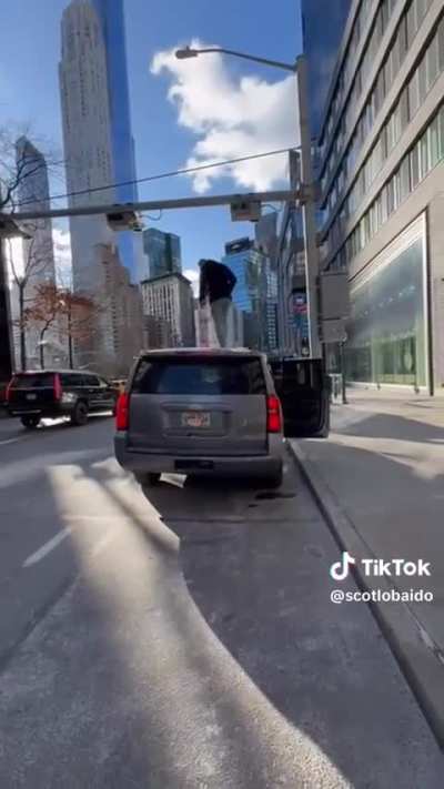 A guy protesting the NYC congestion pricing gives a solid middle finger rating