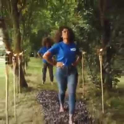 2 beautiful African American women walk on hot coals