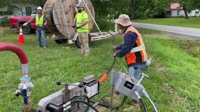 Fiber optic blowing machine. Using air pressure and hydraulics to blow a fiber-optic cable through a empty conduit at over 300 ft./min. to a distance of more than 5000 feet away.