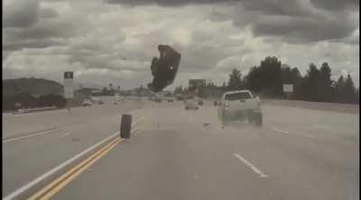 Tire comes off lifted truck causing Kia to go airborne
