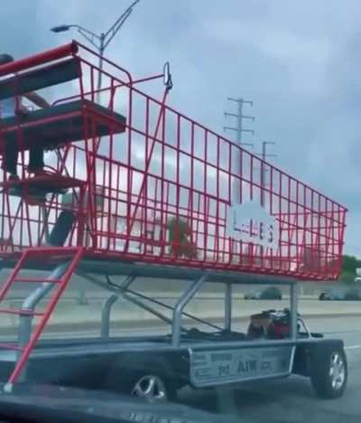 Dude driving a shopping cart down the highway in Texas