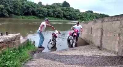 to get his motorbike out of the water