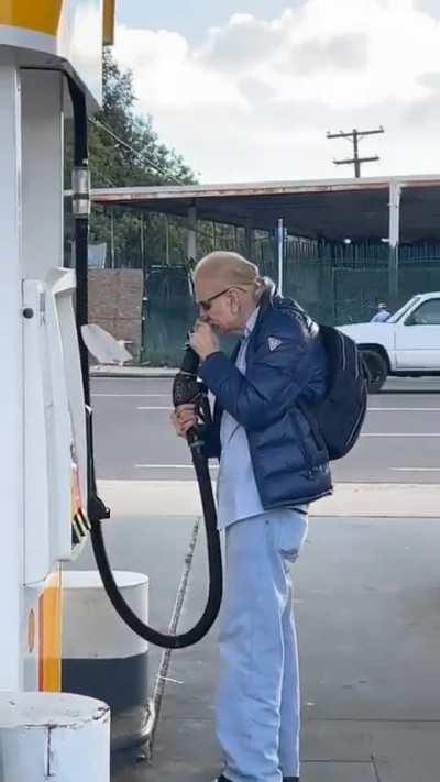 Dude gets caught sniffing the gas pump nozzle