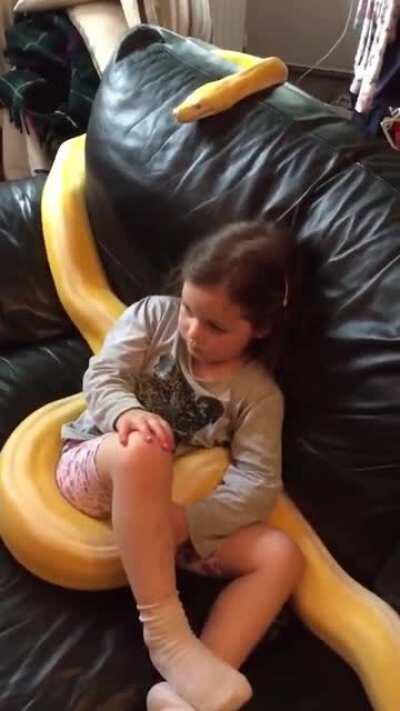 Just a little girl watching TV with her 12ft pet snake