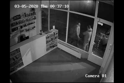 Angry woman headbutts a shop window and the guy casually walks away