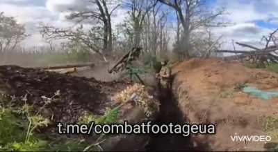 Ukrainian soldiers fire at Russian positions from a makeshift turret consisting of two twin RPGs.