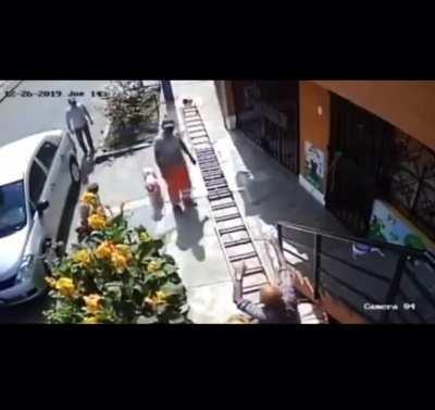 Man in wheelchair shakes a painters stepping stool since it was impeding the asphalt