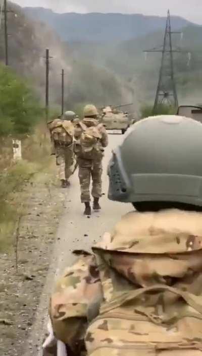A column of Azerbaijani soldiers with armored vehicles advance againts Russia backed Artsakh Defence Army in Karabakh while gunfire can be heard. Sep 19 2023