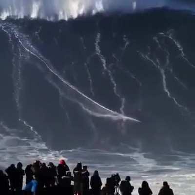 guy surfs a 100 plus ft high wave