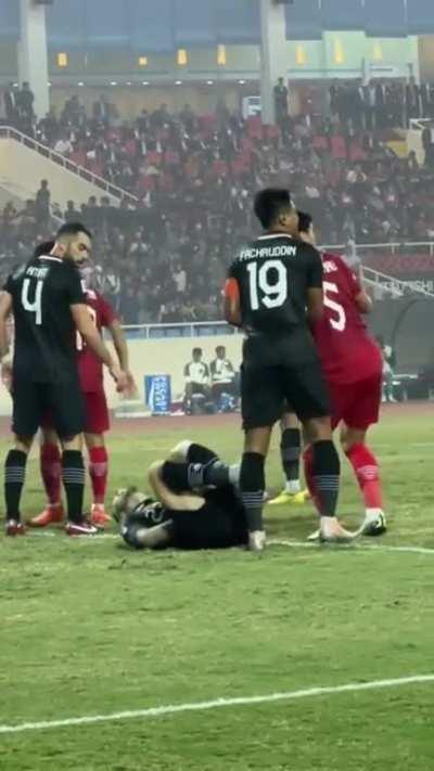 Indonesian soccer player trying to get a foul.