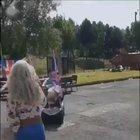 Driving a scooter with two huge flags