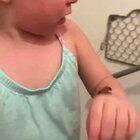 Toddlers reaction after her mom tells her the chocolate pudding on her arm is poop.