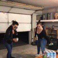 Two girls smashing cans...