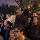 French citizens sing together on the street near Notre-Dame Cathedral ablaze in Paris