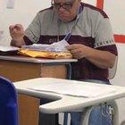 Teacher grading papers in class